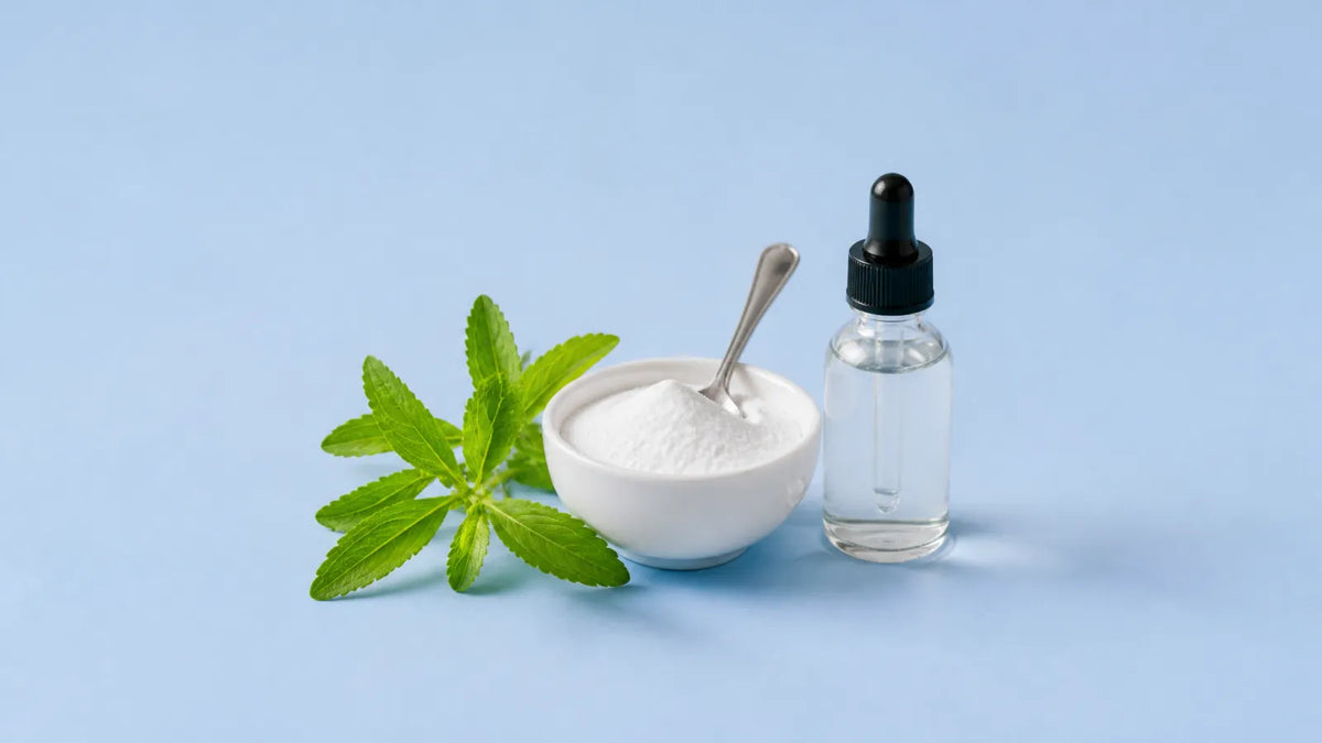 Fresh stevia sprig beside a small bowl of white sweetener powder and a plain, unlabelled dropper bottle