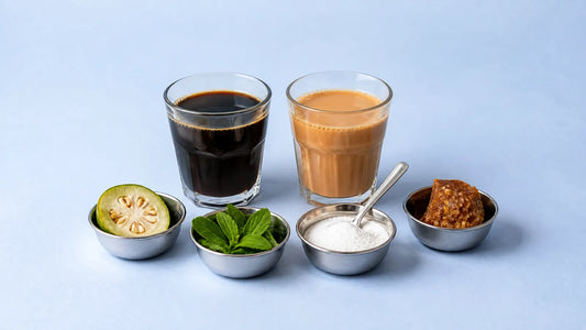 Glass of black coffee and a glass of chai with four steel katoris holding monk fruit, stevia leaves, white powder and gur